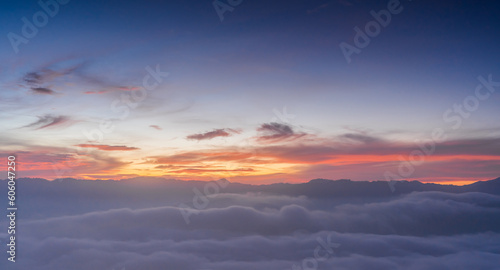 sunset sky clouds over mountains with sea mist in the morning with colorful sunrise