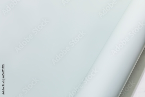Paper background. Light blue paper  sheet with twisted corner. Template. Flat lay