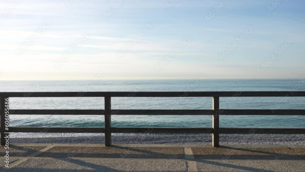 Cinematic static view from wooden pier on seashore of beautiful seascape on sunny evening during sunset in northern France, nobody. Concept of calmness, silence. Shooting in slow motion. Cinematic static view from wooden pier on seashore of beautiful seascape on sunny evening during sunset in northern France, nobody. Concept of calmness, silence. Shooting in slow motion.