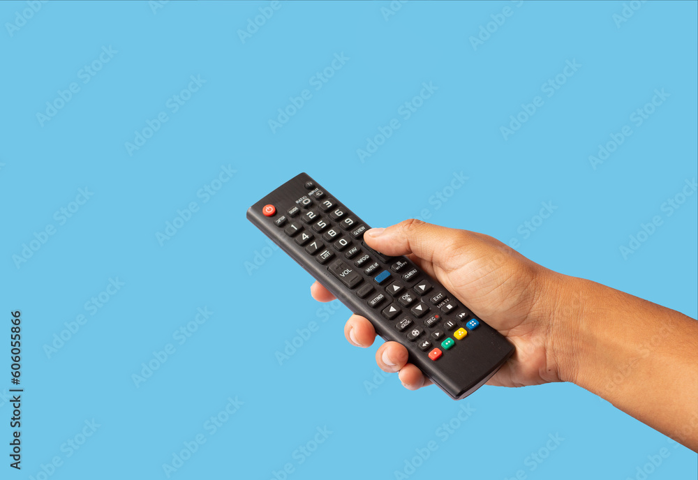 a man's hand holding a control a man's hand holding a control