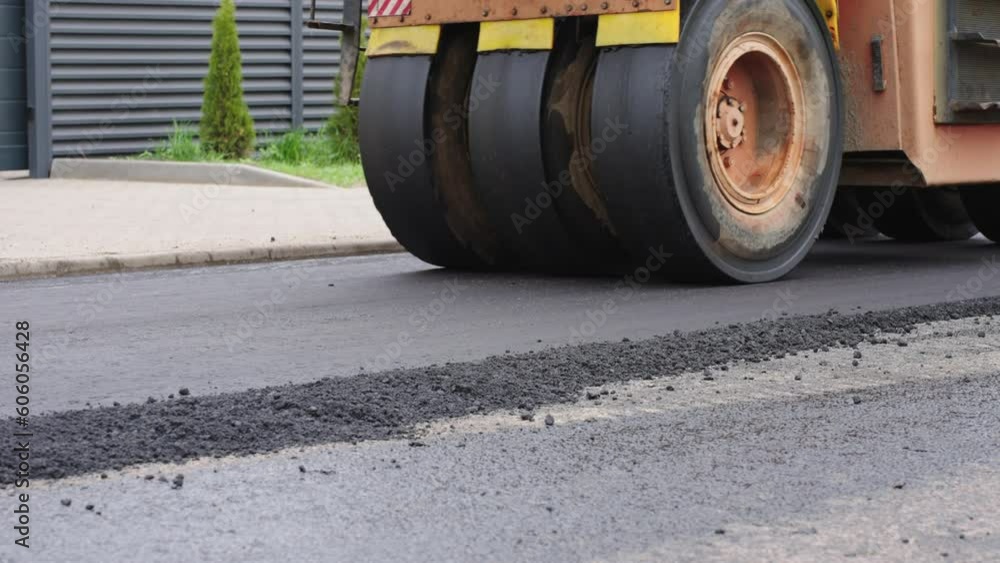 Roller levels the newly laid asphalt. Roadway repair. Asphalt laying. Roller levels the newly laid asphalt. Roadway repair. Asphalt laying.