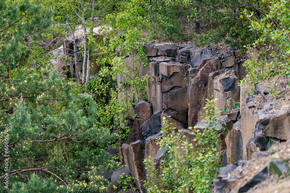 Basalt pillars in an abandoned quarry. Abandoned basalt quarry as a natural monument