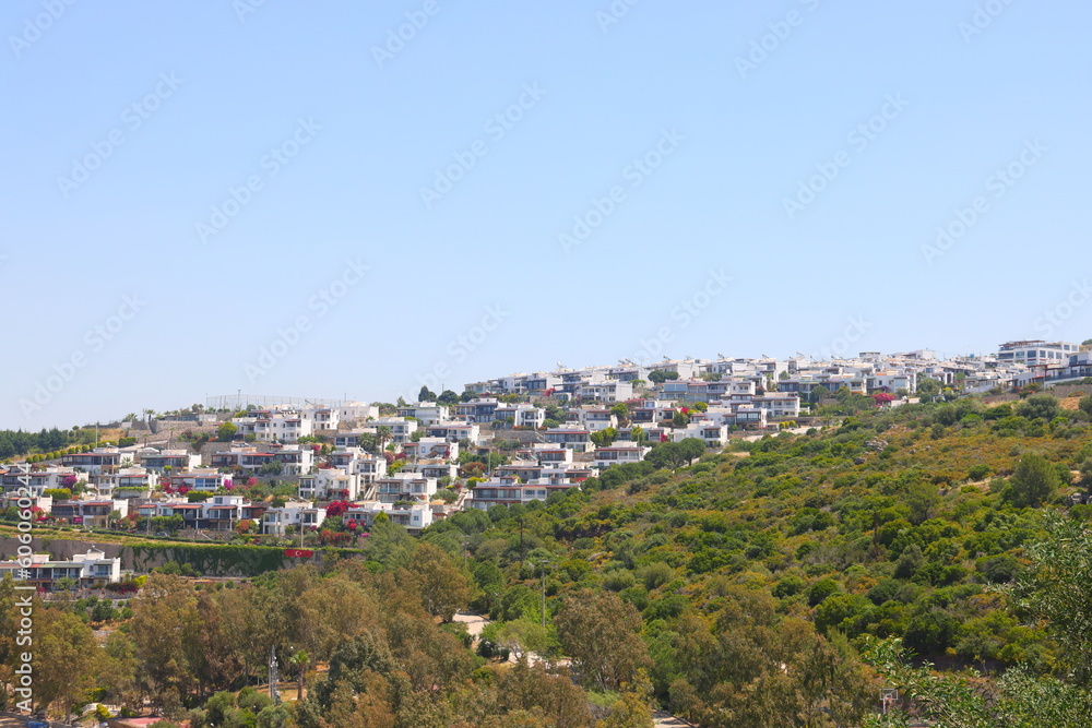 View of the highway, houses and mountains on the Aegean coast of Turkey, orange groves. Turkiye, May 2023.