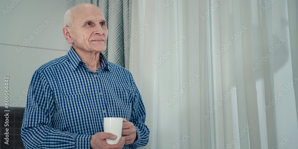 Portrait of old alone man with white coffee cup inside of room. Old people social isolation problem concept. - obrazy, fototapety, plakaty 