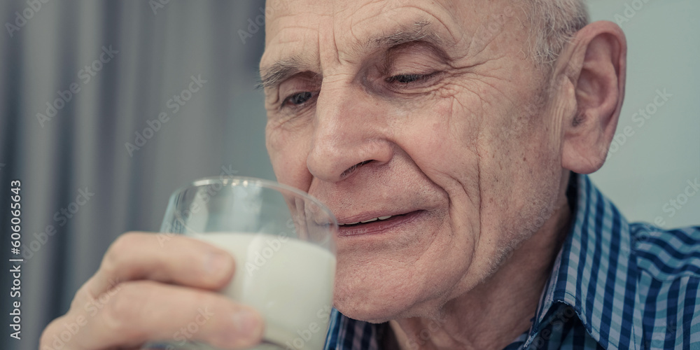 Face of older man drinking fresh milk from glass close up view. Milk nutrients include calcium, potassium, vitamin D and protein Face of older man drinking fresh milk from glass close up view. Milk nutrients include calcium, potassium, vitamin D and protein