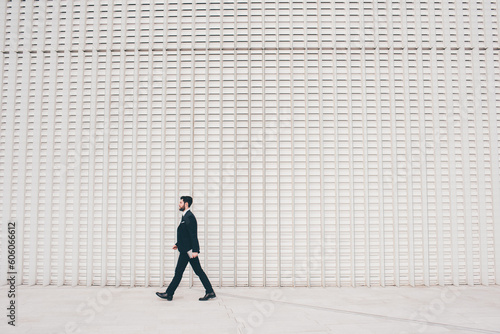 Fotografie, Obraz Confident and professional elegant bearded businessman walking outdoor