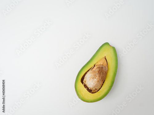 Cut ripe avocado on white background