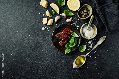Mediterranean food ingredients on dark stone background. Copy space. Flat lay
