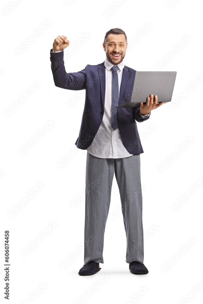 Businessman in a suit and bottom pajamas holding a laptop computer and gesturing happiness Businessman in a suit and bottom pajamas holding a laptop computer and gesturing happiness