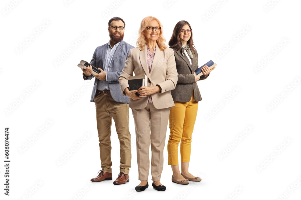 Fototapeta premium Team of teachers holding books and posing