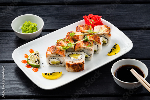 Set of sushi rolls with smoked tuna, cream cheese, sweet pepper, wasabi, ginger and soy sauce.