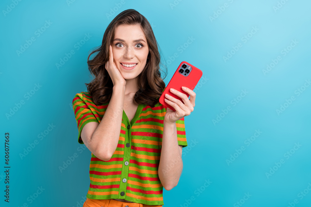Photo of funky girl touch cheek blogger unexpected how incoming notifications she get after announce raffle isolated on blue background Photo of funky girl touch cheek blogger unexpected how incoming notifications she get after announce raffle isolated on blue background