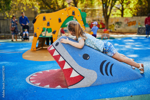 Adorable little girl on playground on a sunny day