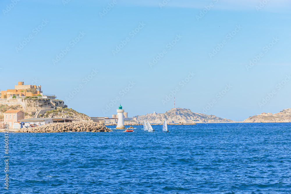 A scenic view of the entrance of the port of Marseille, bouches-du-rhône, France under a majestic blue sky