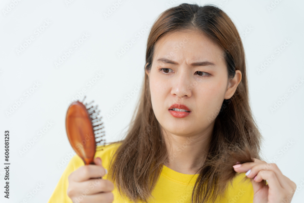 Asian woman very sad and upset looking at damaged hair, hair loss, hair thinning problem, vitamin deficiency, baldness, postpartum, biotin, zinc, menstrual or endocrine disorders, hormonal imbalance Asian woman very sad and upset looking at damaged hair, hair loss, hair thinning problem, vitamin deficiency, baldness, postpartum, biotin, zinc, menstrual or endocrine disorders, hormonal imbalance