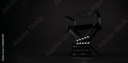 Director chair and clapper board on black background