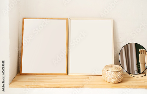 set of empty wooden photo frames for mockup design on the wooden shelf