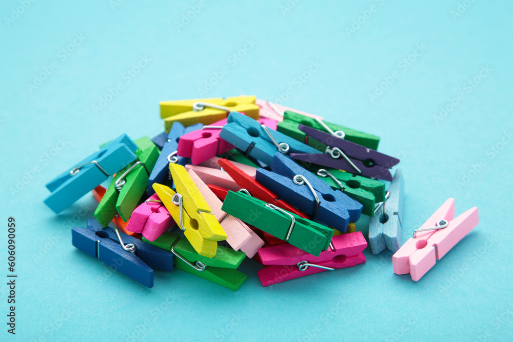 Colored wooden clothespins on blue background. Design elements. Macro.