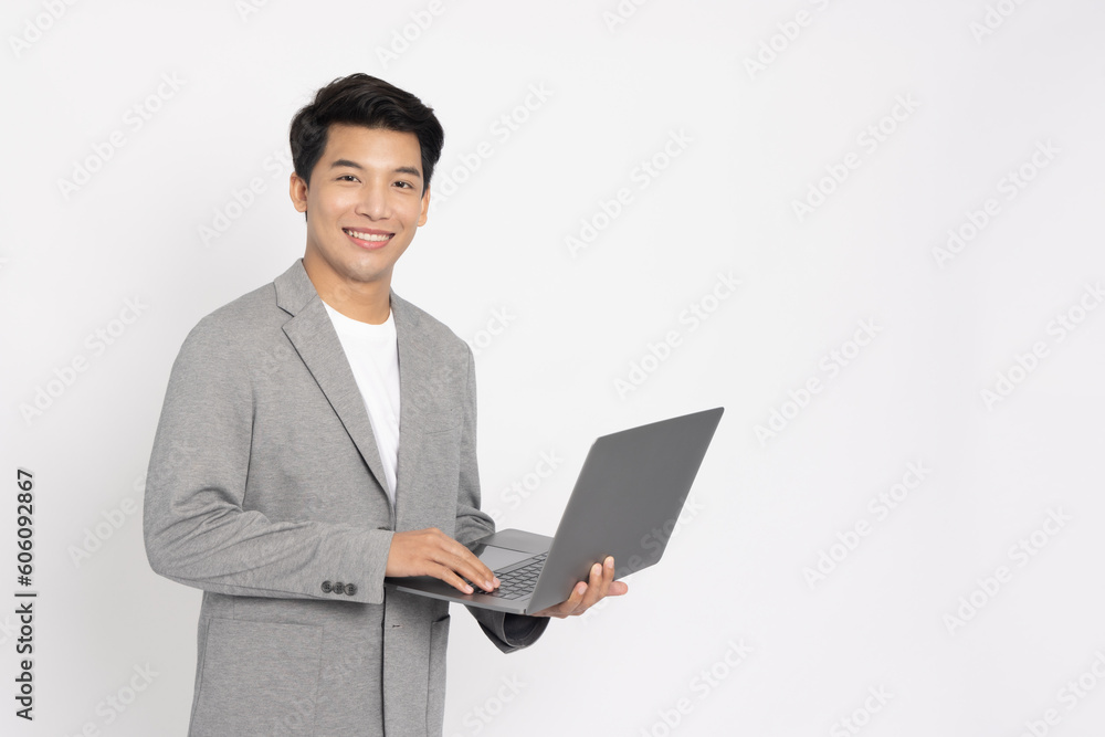 Happy young Asian business man using laptop computer isolated on white background