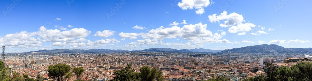 A scenics aerial panomaric view of the city of Marseille, bouches-du-rhône, France under a majestic blue sky and some white clouds