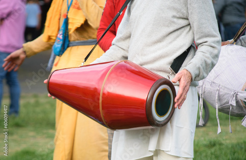 Drummer hands playing Mridanga or Satnam drum with light and cheerful clothes photo