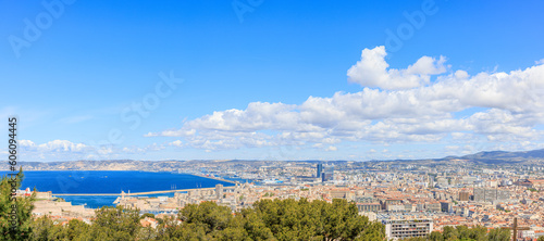 A scenics aerial view of the city of Marseille, bouches-du-rhône, France under a majestic blue sky and some white clouds © Dolwolfian