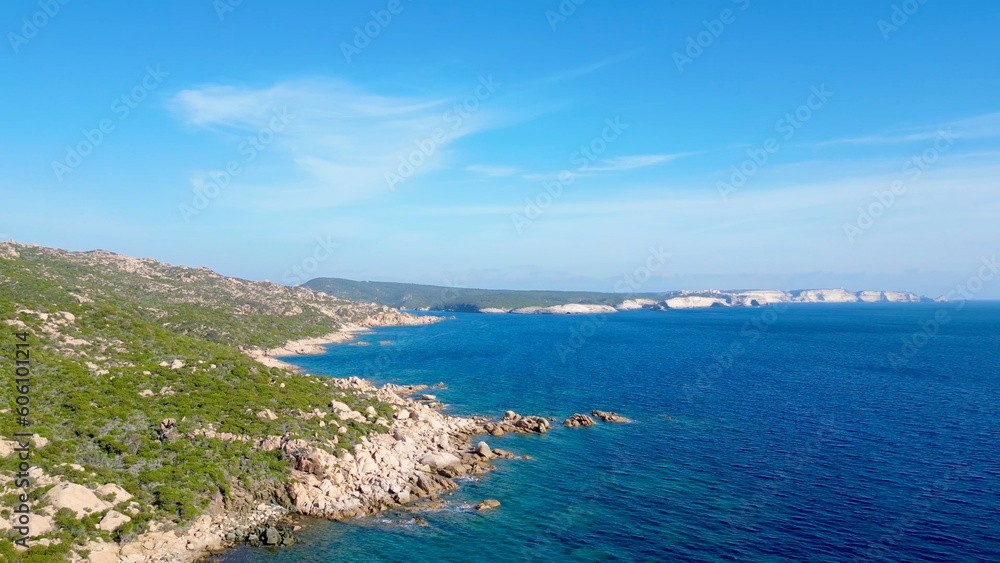Dance of Land and Sea: A Scenic Rightward Journey over Mount of the Trinity Coast, Bonifacio, Corsica – Revealing the Wild Beauty of Rugged Coastlines and Infinite Ocean