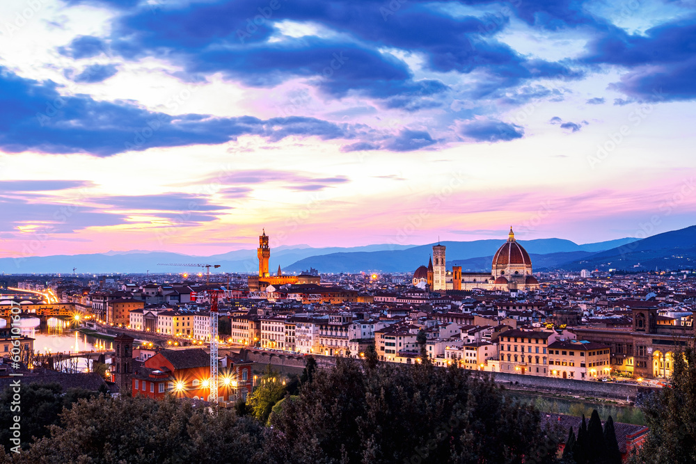 The view of the Ponte Vecchio, the towers of the Palazzo Vecchio and the Cattedrale di Santa Maria del Fiore from Piazza Michelangelo in Florence at sunset.