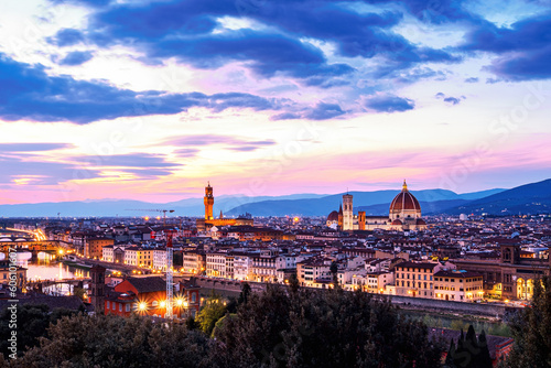 The view of the Ponte Vecchio, the towers of the Palazzo Vecchio and the Cattedrale di Santa Maria del Fiore from Piazza Michelangelo in Florence at sunset. © qingyao