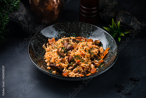 Dinner pilaf with with lamb, raisins, almonds, carrots, tomatoes, onions and herbs.