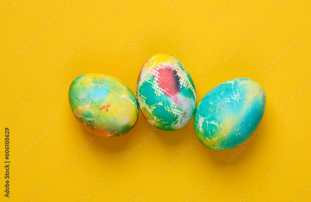 Multicolored Easter eggs on a yellow background
