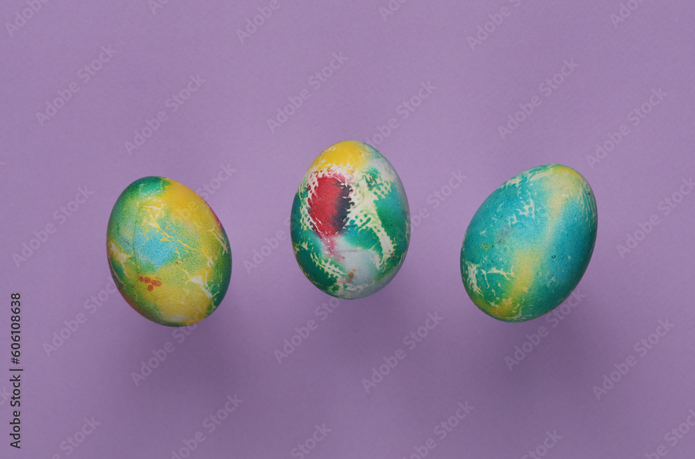 Multicolored Easter eggs on a purple background Multicolored Easter eggs on a purple background