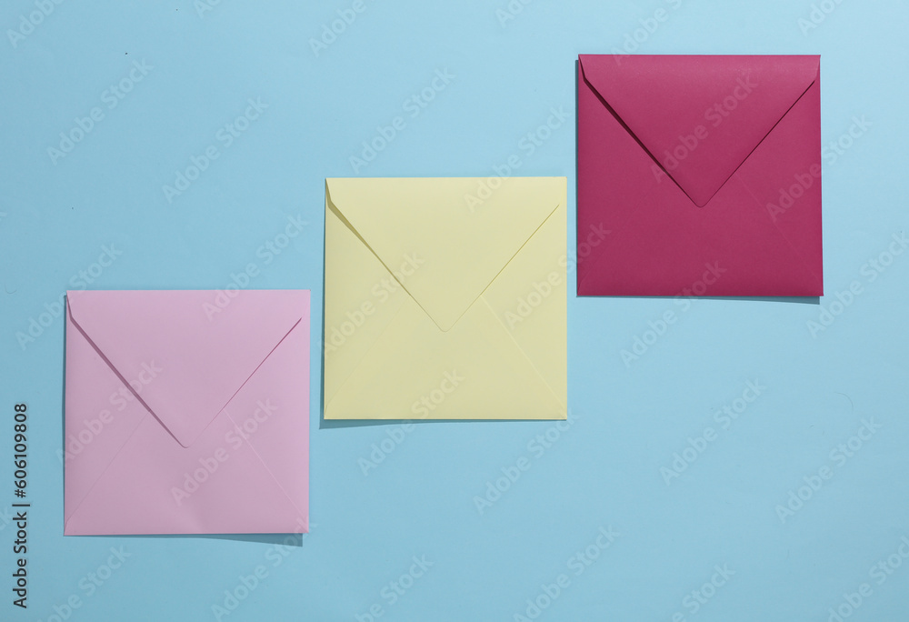 Square colored envelopes on a blue background Square colored envelopes on a blue background