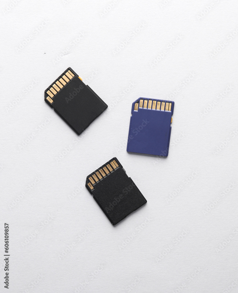 Three sd memory cards on gray background Three sd memory cards on gray background