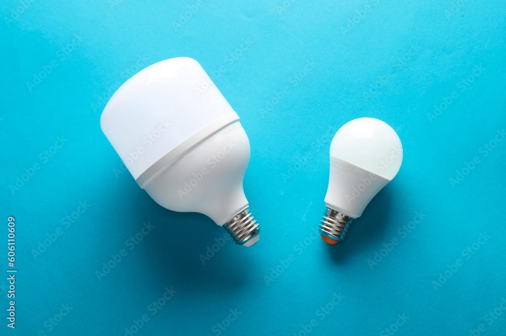 Fotografie Big and small led light bulbs on a blue background