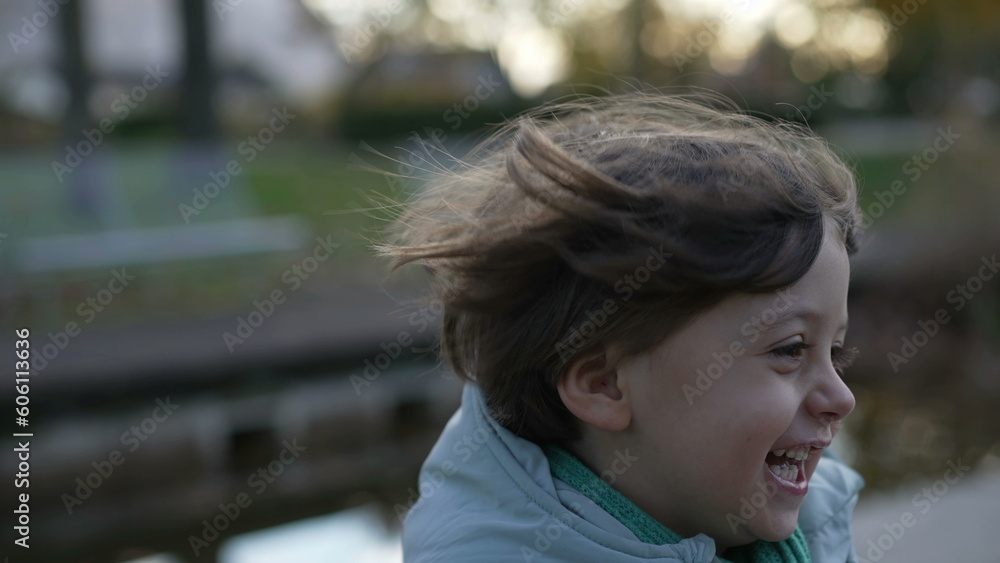 One active little boy runs outside in slow motion in handheld. Happiness concept of child running outdoors and laughing One active little boy runs outside in slow motion in handheld. Happiness concept of child running outdoors and laughing