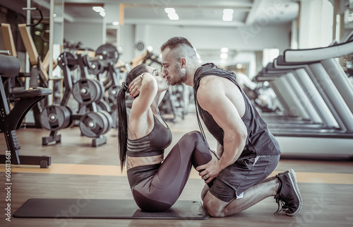 Couple in love training in the gym and kissing. Healthy lifestyle. Abs workout