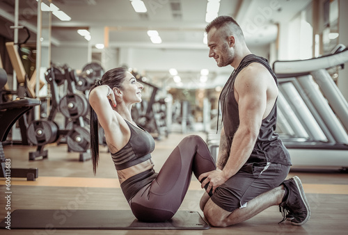 Couple in love training in the gym. Healthy lifestyle. Abs workout