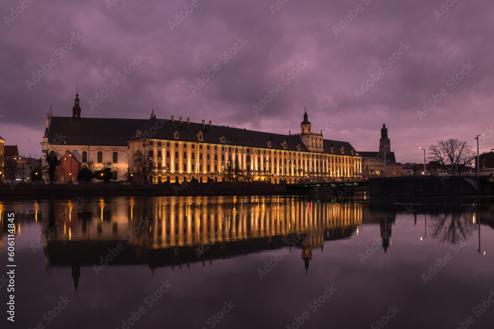 Wroclaw University building with reflection in the river.