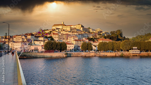 Coimbra city seen from across the Mondego River at sunset  Portugal