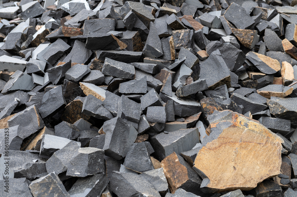 Pile of broken granite stones. Many pieces of broken stone. Wastes from the production of granite products Pile of broken granite stones. Many pieces of broken stone. Wastes from the production of granite products
