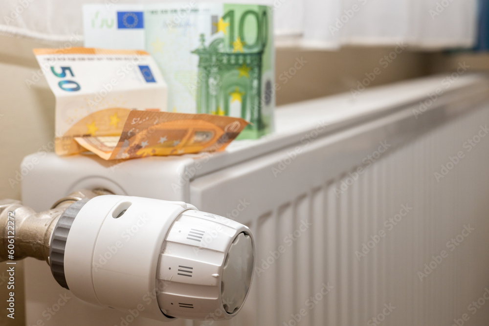 Radiator and Euro money, European currency, 50 and one hundred euro banknotes, The concept of the price of heating apartments with gas and coal electricity