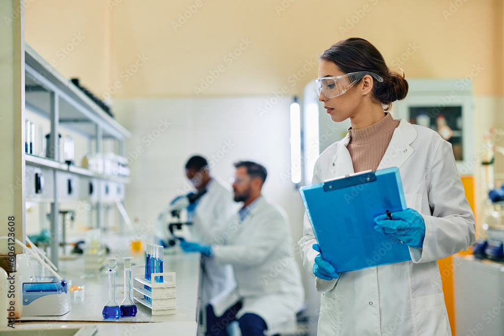 Female biochemist working with test substances in laboratory. Female biochemist working with test substances in laboratory.
