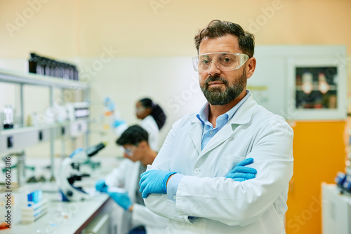 Confident male scientist in laboratory looking at camera.