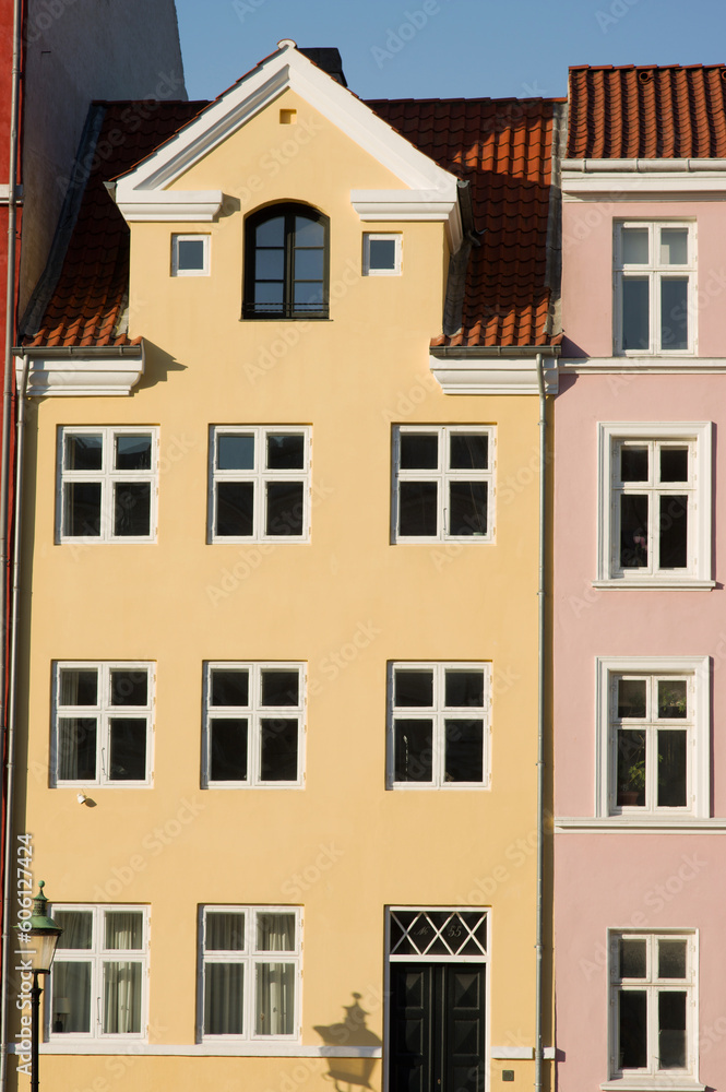 Yellow historic terraced house in Nyhavn in the center of Copenhagen in Denmark