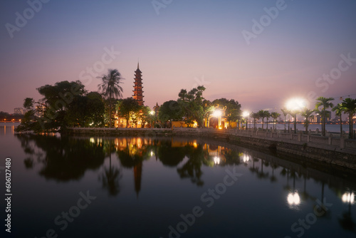 West lake and water reflection of illuminated Tran Quoc Pagoda - the oldest Buddhist temple in Hanoi at twilight, Vietnam..