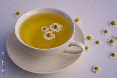Herbal drink tea with fresh chamomile flowers white cup copy space, healthy medicinal Rural still-life isolated on white table background Beautiful composition calming top view.