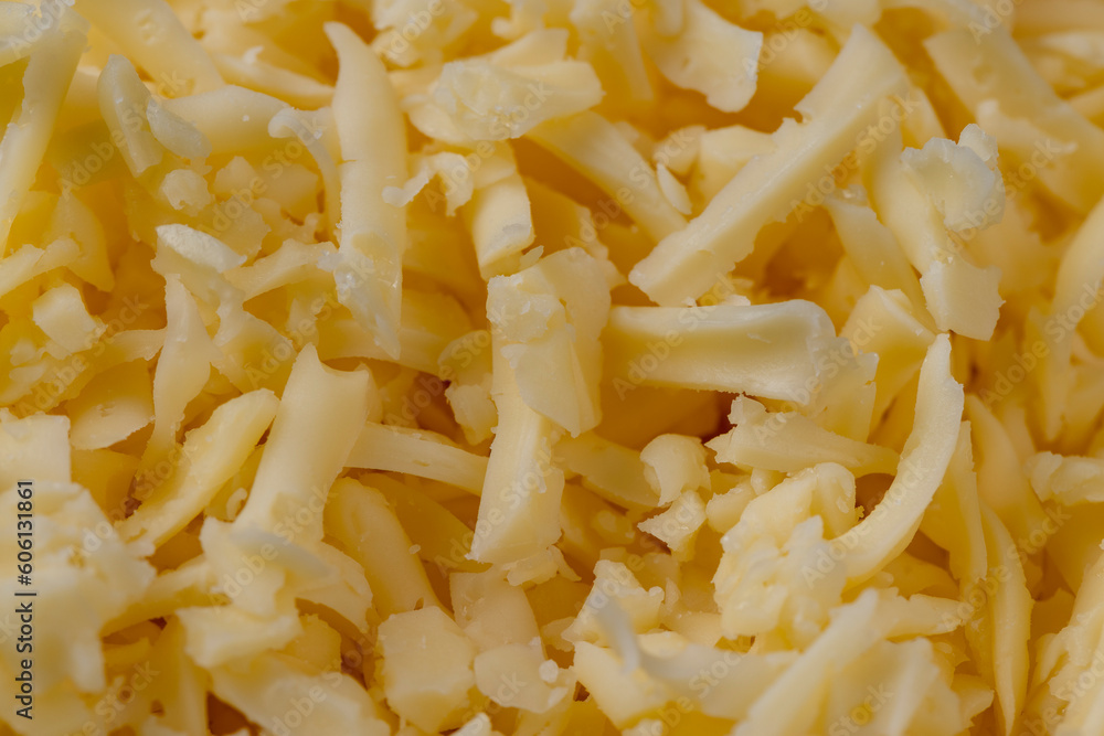 Hard cheese with holes grated into thin small slices Hard cheese with holes grated into thin small slices