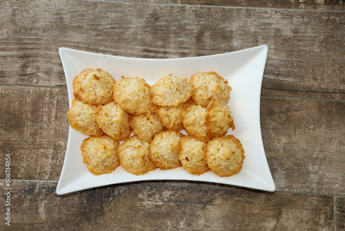 Top view of coconut macaroons (cocadas) on a white serving plate.