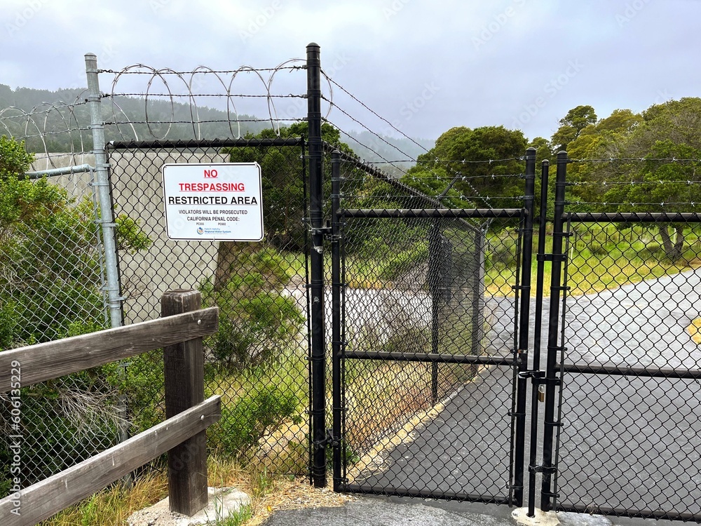 No Trespassing Sign With Barbed Wire Fence and Gate at Crystal Springs Water Reservoir of Hetch Hetchy System in San Mateo County, San Francisco Bay Area, California near San Andreas Fault No Trespassing Sign With Barbed Wire Fence and Gate at Crystal Springs Water Reservoir of Hetch Hetchy System in San Mateo County, San Francisco Bay Area, California near San Andreas Fault
